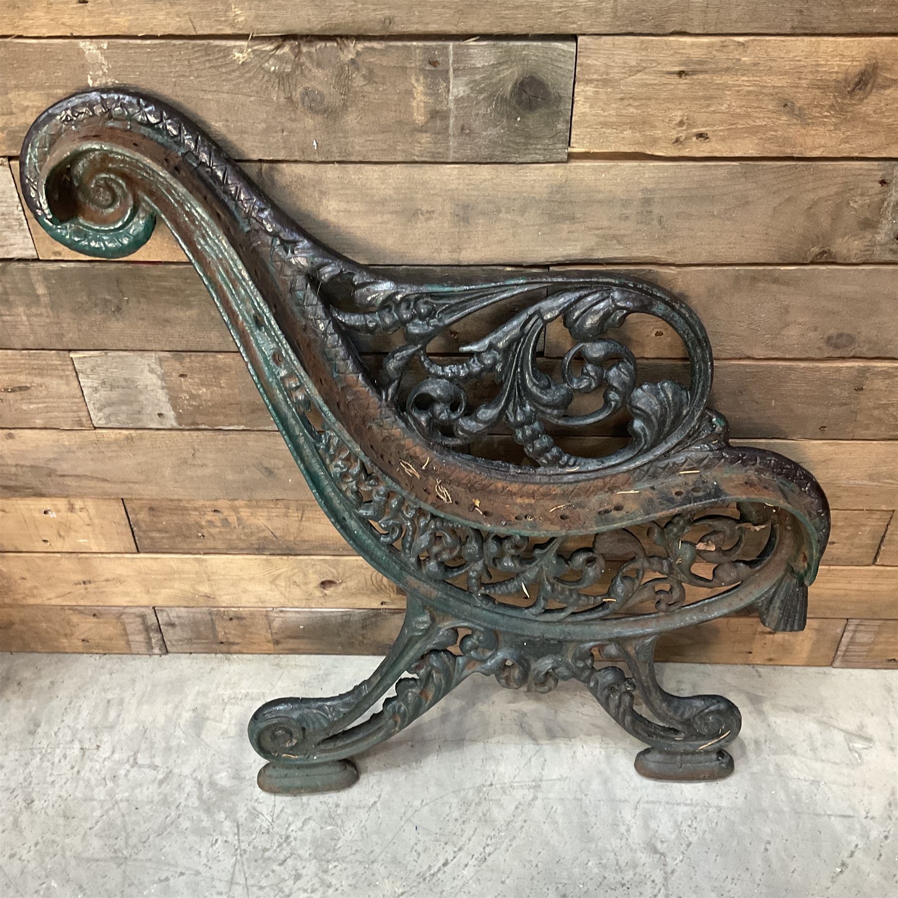 Early 20th century heavy cast iron three piece bench ends, decorated with scrolls and floral swags