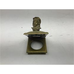 Collection of victorian and later brass desk accessories, to include a letter holder with cherub design, ink well of square form with hinged lid, brass table bell, brass casket with relief decoration, etc  