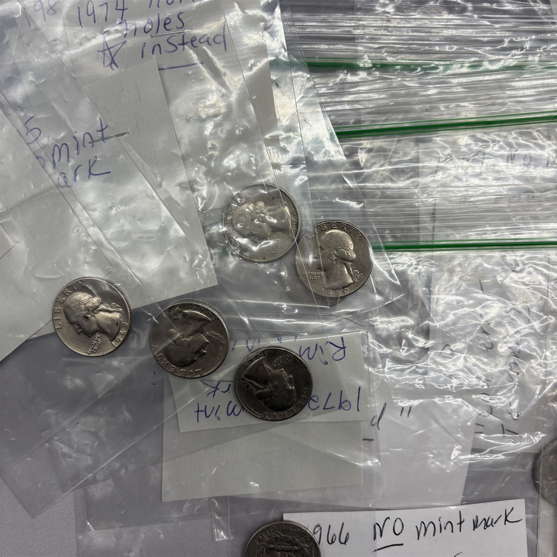 Collection of United States of America coins, 1965 onwards, principally quarter dollars, many with alleged minting errors as annotated on labels