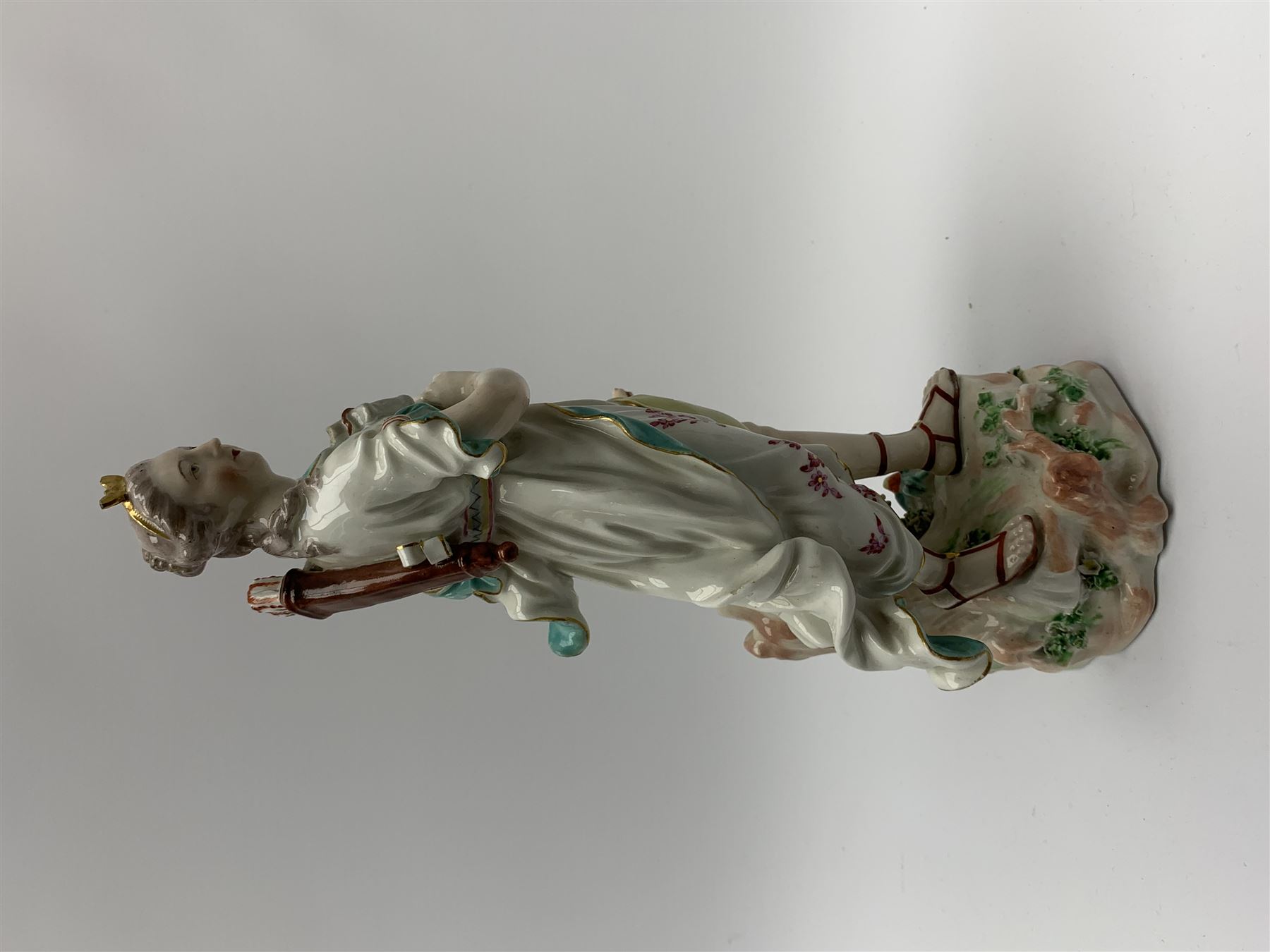 Mid 18th century Derby porcelain figure modelled as Dianna the Huntress, with quiver of arrows upon her back and dog by her side, upon a naturalistically modelled base, with patch marks beneath and collectors labels, H26cm