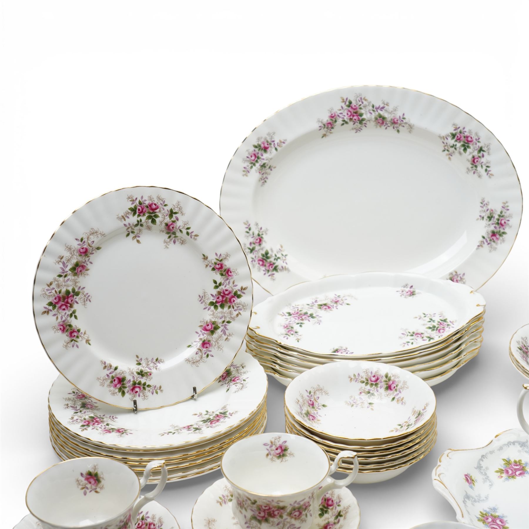 Royal Albert Lavender Rose tea and dinner wares, comprising eight dinner plates, and eight small dinner plates, eight side plates, open serving dish, teapot, open sucrier, salt and pepper, sandwich plate, sauce boat and saucer, eight teacups and saucers, six bowls, six oval serving dishes, and one platter