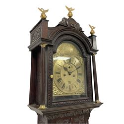 18th-century profusely carved oak longcase clock - with a pagoda pediment, upstands and carving, 
 break arch hood door flanked by reeded pilasters with brass capitals, trunk with canted corners and a spire topped door, square plinth with applied skirting, break arch brass dial with wheatsheaf engraving and cast cherub and crown spandrels, engraved break arch with the London clockmakers name John Gordin, silvered chapter ring with Roman numerals, five minute Arabic's, minute and quarter hour tracks, matted dial centre with ringed winding holes, square date aperture and seconds ring, dial pinned to a five pillar movement with inside countwheel striking, striking the hours on a cast bell. With weights and pendulum. John Gordin, is possibly a mis-spelling or phonetic spelling of John Gordon, of London, who worked from Ludgate Street in the parish of St. Gregory by St. Pauls. Apprenticed in 1689 and died in 1732 when his will was proven.
