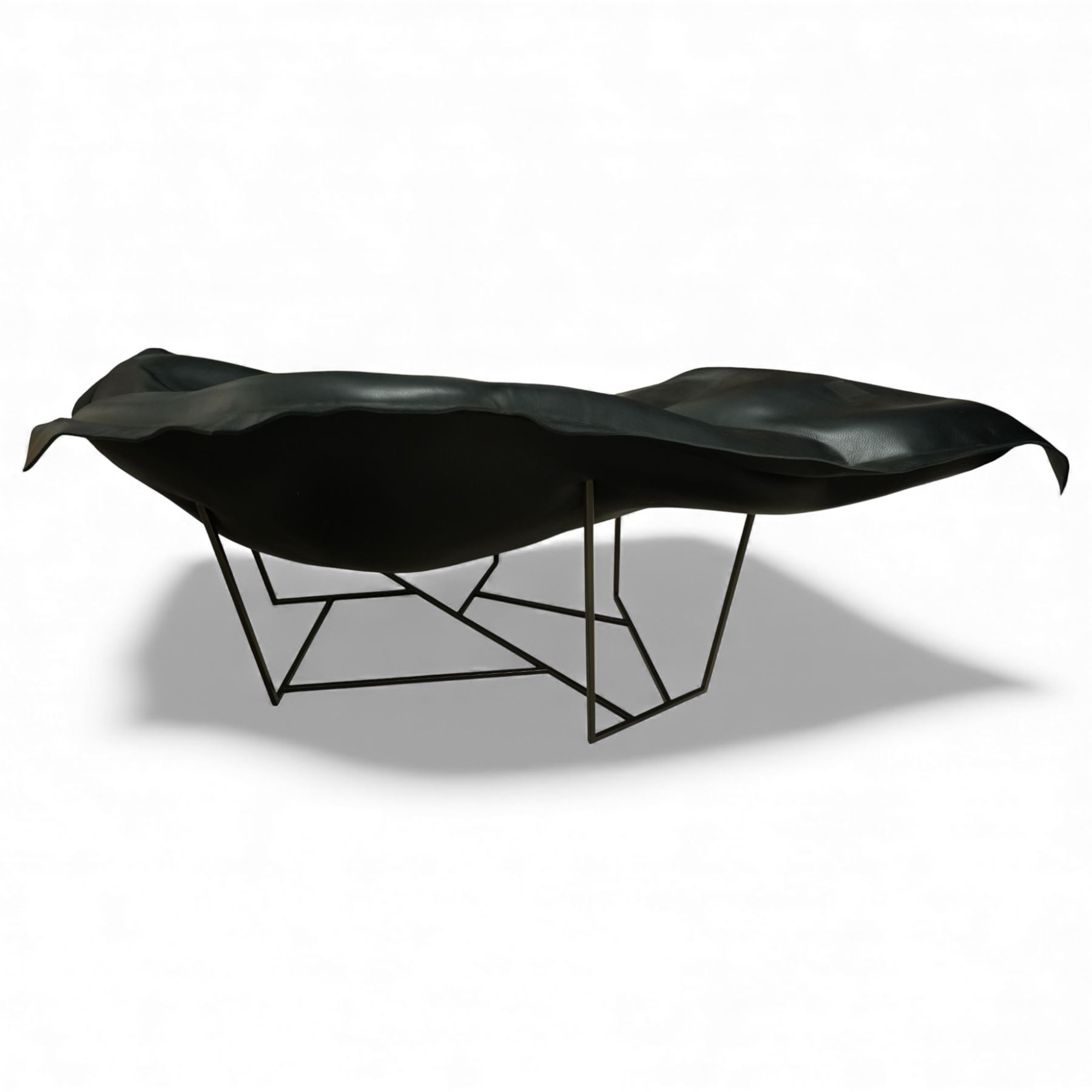 Poliform - ‘Wallace’ armchair, sculptural leaf-form silhouette upholstered in black leather, raised on triangular metal supports