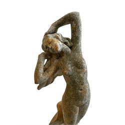 Cast stone two-piece garden figure of the Birth of Venus, depicting the goddess emerging from a stylised shell, on square base with stepped moulded plinth 