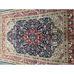 Persian Saroug rug, blue ground with interlacing foliate design, central medallion decorated with stylised flower heads, repeatin guarded border, 297cm x 196cm