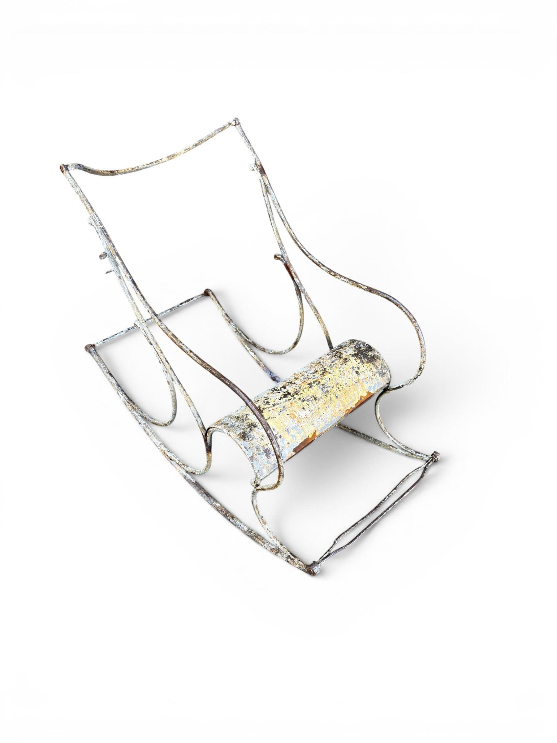 Pair of white painted cast metal garden chairs, ornate reclined backs, circular pierced seats on cabriole legs