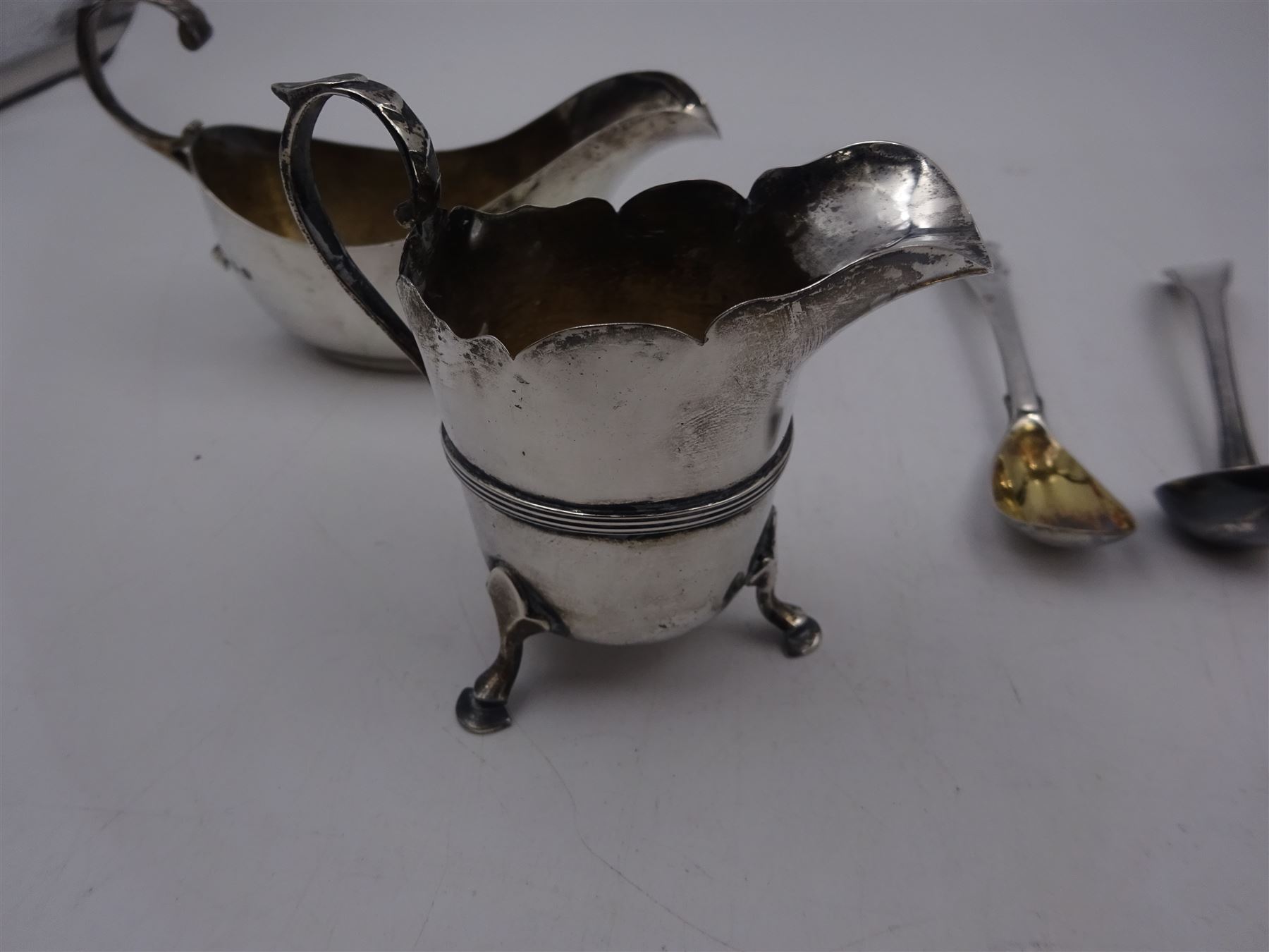 Pair of Georgian silver Old English pattern spoons, hallmarked Thomas Wallis II, London 1791, together with a silver sauce boat, silver cream jug and two other silver spoons, all hallmarked 