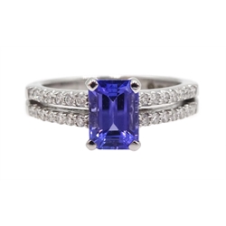  18ct white gold emerald cut tanzanite ring, the shank with two rows of round brilliant cut diamonds, hallmarked  