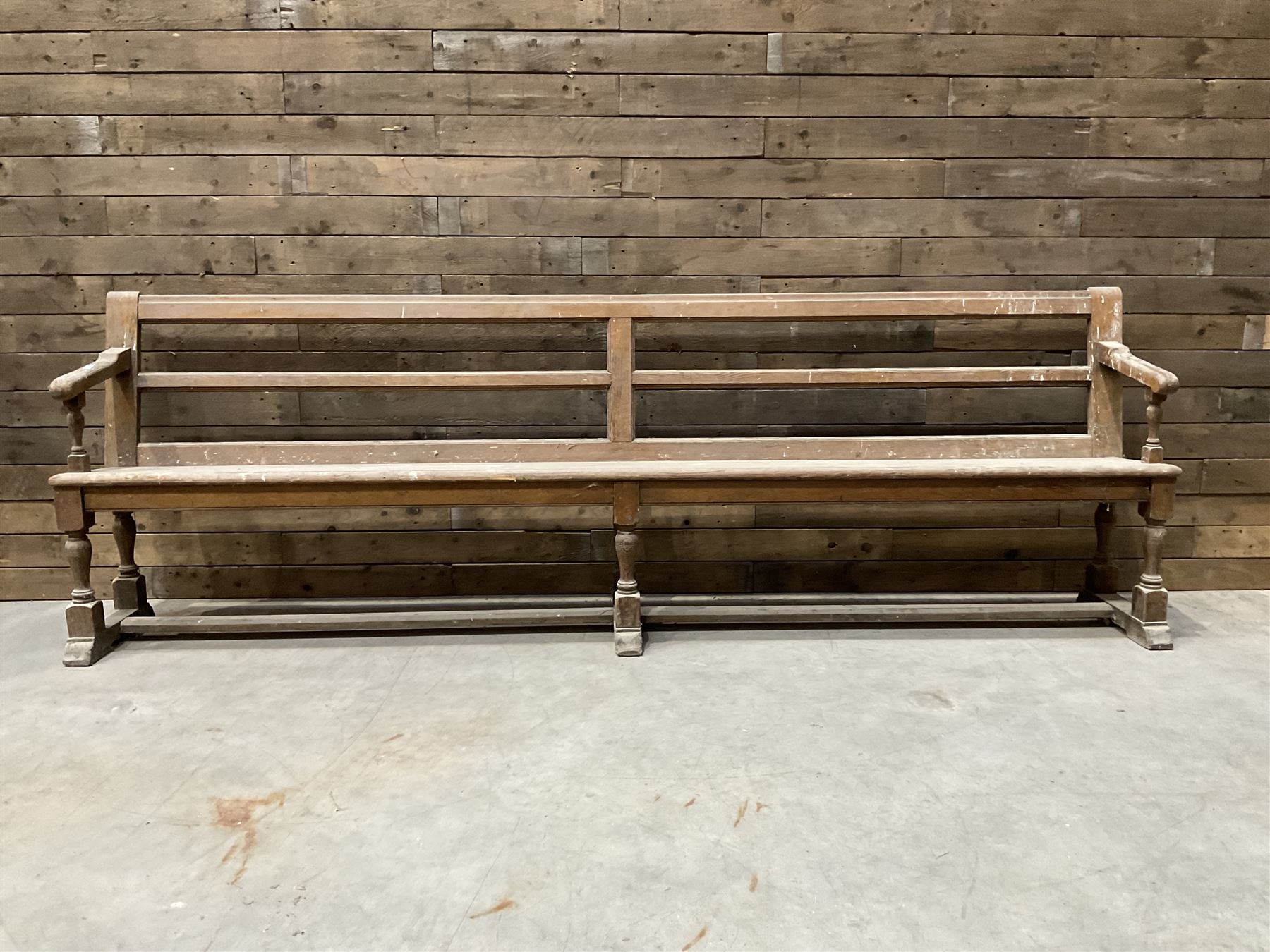 Victorian pitch pine bench pew, turned arms and legs, rail back with plank seat, 274cm