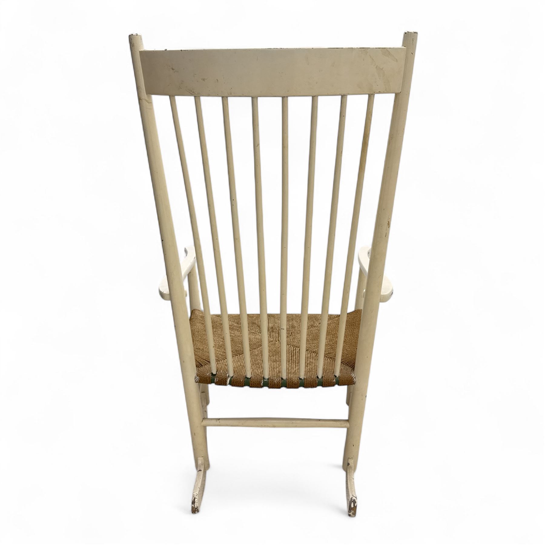 Mid-20th-century Scandinavian painted high-back rocking chair, curved top rail above slender spindle back, shaped arms with rounded ends above hand-woven rush seat, tapered rockers reinforced by turned stretchers 