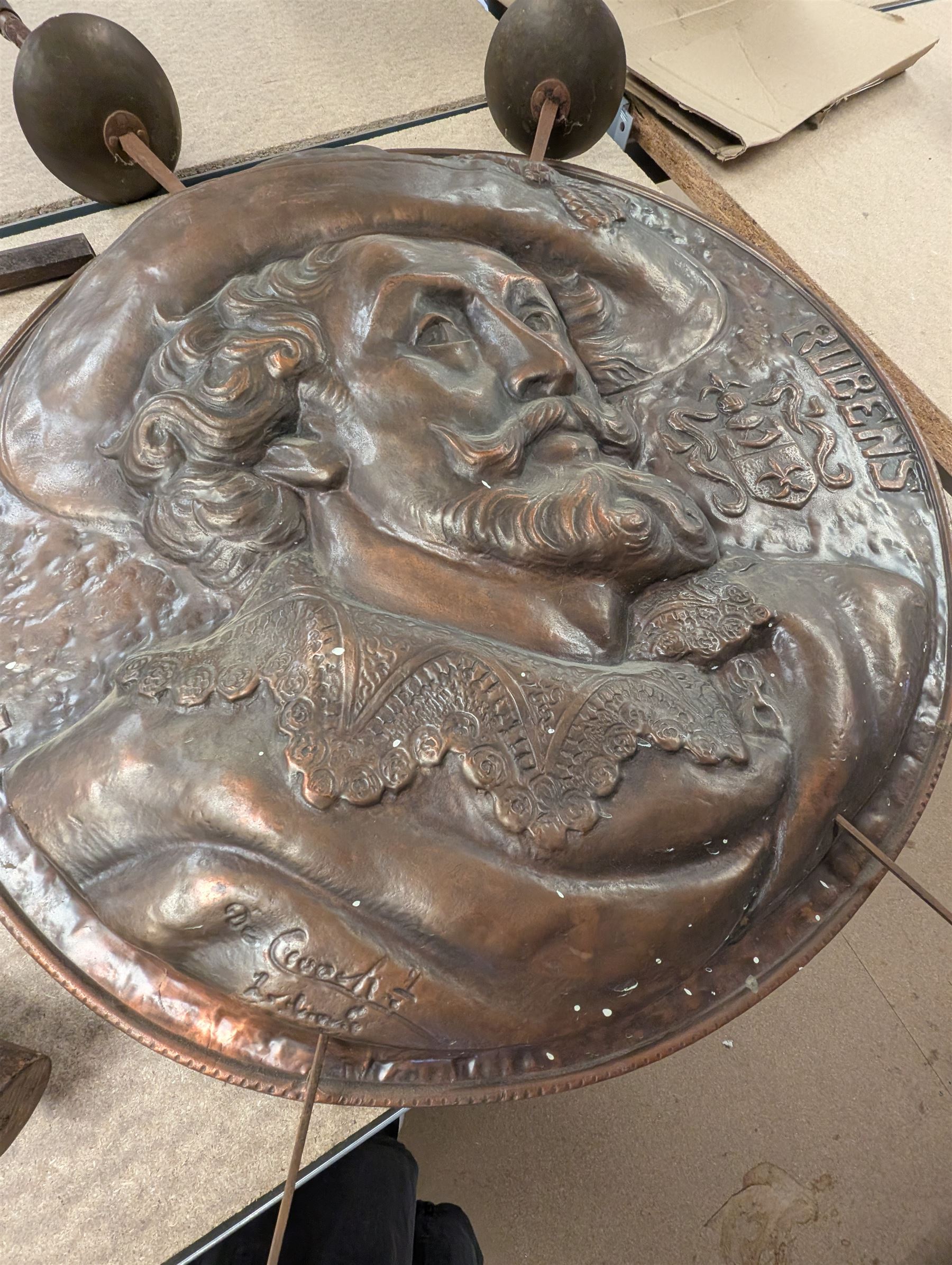 Copper shield and two rapiers, the shield depicting Peter Paul Rubens in relief,  together with a brass Sir Galahad charger, battle axe, mace, replica prop gun, etc