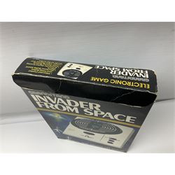 Three late 70s/early 80s handheld electronic games; Bandai Electronics Arcade ‘Gunfighter’ (1980), Grandstand ‘Invader From Space’ (1980), Palitoy ‘Merlin The Electronic Game Machine’ (1979) with game sheet and instruction booklet, all with original boxes (3) 