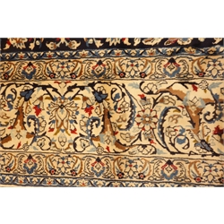  Persian Nain carpet, floral design on dark blue field, central rosette medallion, ivory ground outer border, 430cm x 305cm  