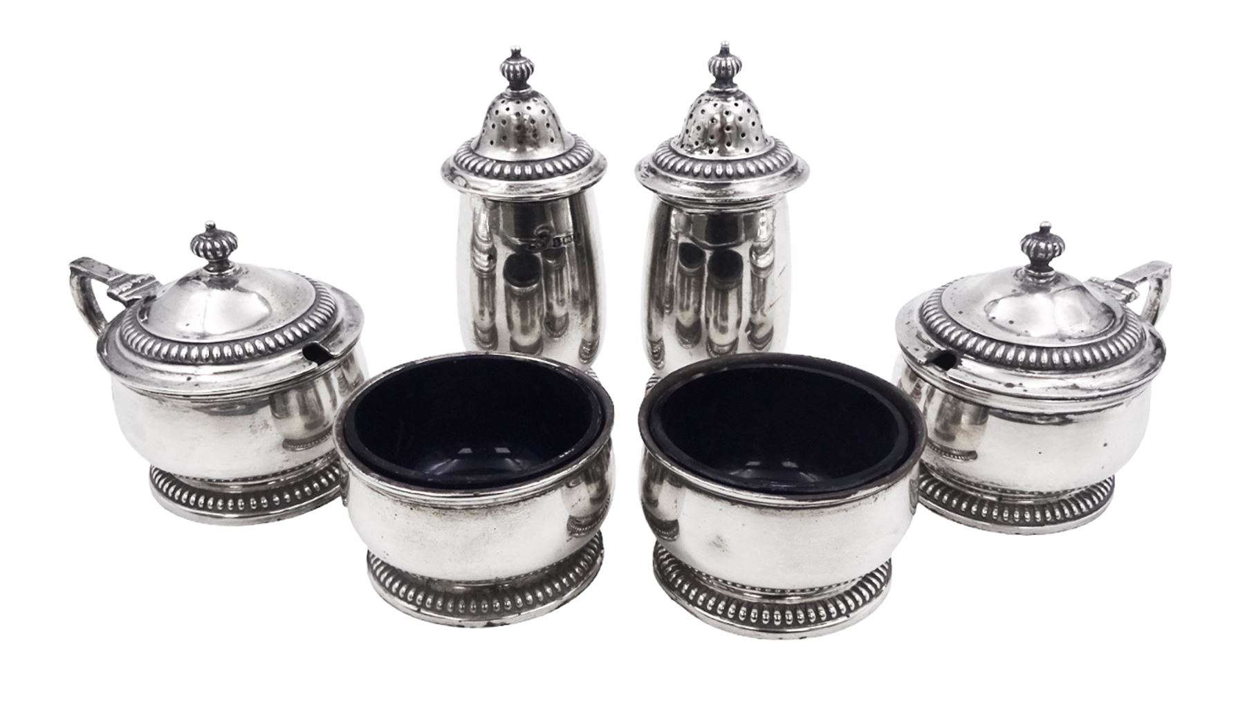 1930s silver six piece cruet set, comprising two peppers, two open salts and two mustard pots with covers, each of plain form with gadrooned rims, mustard pots and peppers each with gadrooned finials, hallmarked Mappin & Webb Ltd, Birmingham 1932 and 1935, mustard pots and salts with blue glass liners