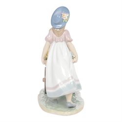 Lladro, Love's tender tokens girl, with floral filled wheelbarrow, model 6521, H23cm