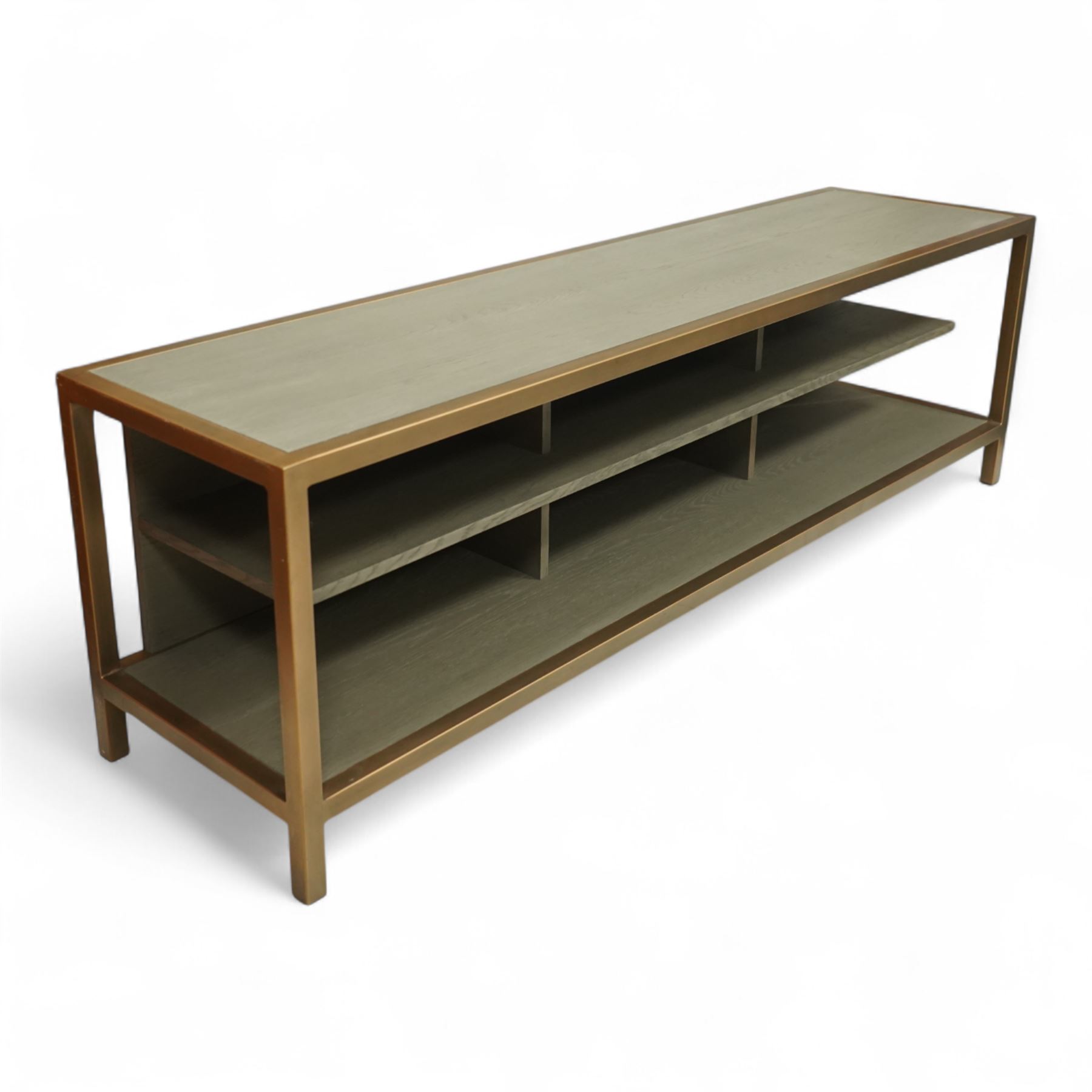 Contemporary low television stand, brass-effect metal frame enclosing six open oak veneered compartments, raised on square tubular supports
