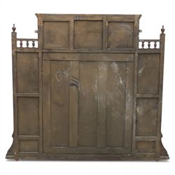 Edwardian walnut overmantel mirror, moulded cornice over three arched apertures with turned supports, flanked by open shelves with turned uprights and finials, carved foliate panels to the base