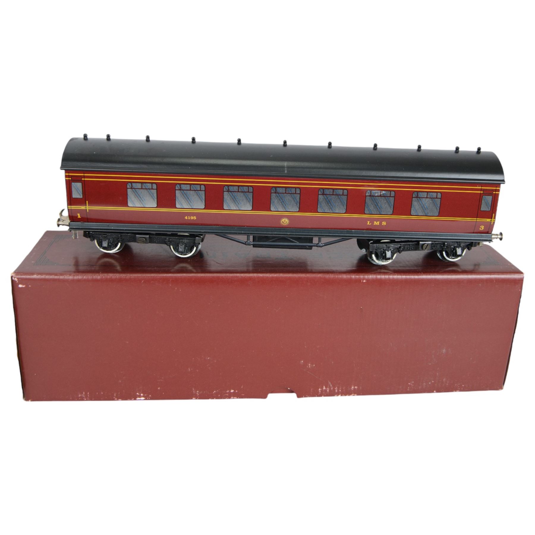 Three 0 gauge coaches, comprising an ACE Trains tin-printed All Third coach in LMS maroon livery, an ACE Trains tin-printed EMU MET 1st coach and a 'neverwazza' goods wagon, painted in Cadbury's Roses livery