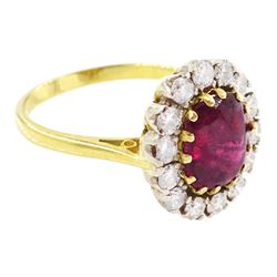 18ct gold garnet and diamond cluster ring, single cabochon cut garnet surrounded by twelve brilliant cut diamonds, London 1970, total diamond weight approx 0.60 carat 