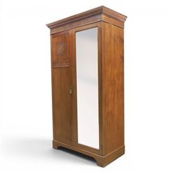 Quality Edwardian mahogany double wardrobe, featuring bevelled mirrored and panelled door with applied moulded detail, internal brass rail hanging and shoe rails