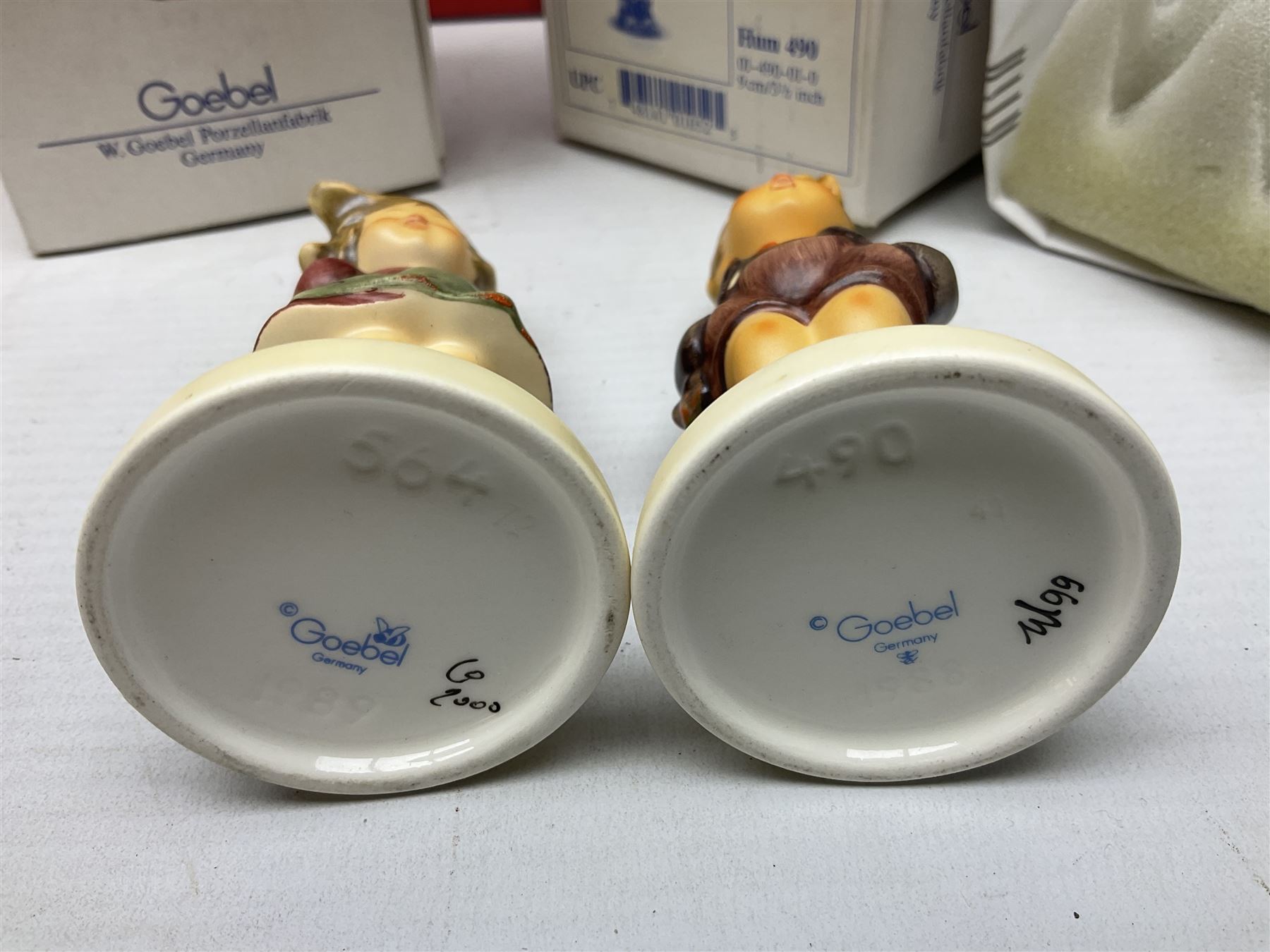 Royal Doulton The Mickey Mouse Collection Pluto figure, Coalport Characters The Snowman Dressing Up figure, three Royal Doulton Bunnykins figures comprising Policeman, Morris Danger and Eskimo, and display stand, Royal Doulton John Beswick Tiggy Winkle, Royal Albert Beatrix Potter Peter Postbag and three Goebel Hummel figures, all boxed