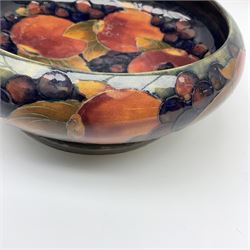 A William Moorcroft bowl on Tudric Pewter base, circa 1914, decorated in the Pomegranate and berries pattern upon blue ground, marked beneath Made In England Tudric Moorcroft 01311, H8cm D21.5cm. 