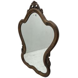 French design stained beech framed wall mirror, shaped and moulded framed with scrolling foliage carved pediment and brackets, plain mirror plate 