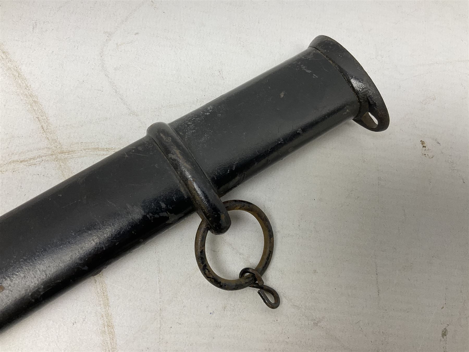 WW2 Japanese Army NCOs sword - katana, the 69.5cm slightly curving fullered blade numbered 14656; arsenal markings stamped near the habaki on the handle; brass tsuba and black painted metal hilt cast to simulate cord bound fish skin; in black painted steel scabbard with single suspension ring L96cm overall
