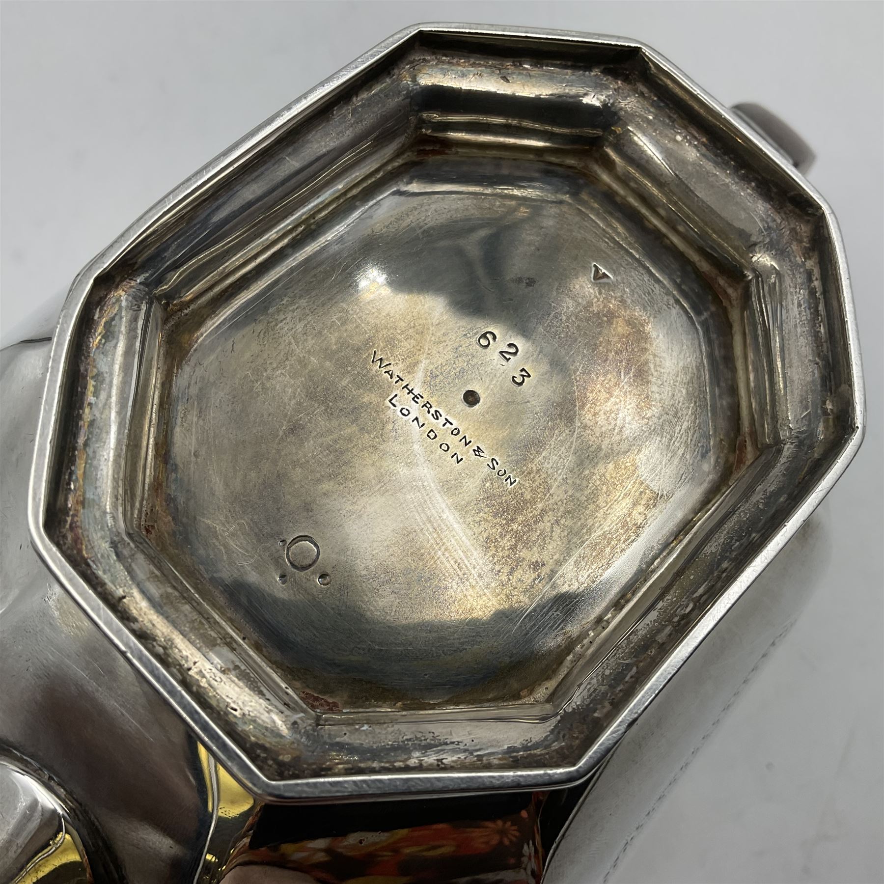 Victorian silver four piece tea service, comprising teapot, teapot stand, twin handled open sucrier and milk jug, each of octagonal form with foliate bud border and engraved decoration including crest to canted panels, and vacant panels, the teapot with ivory finial to the hinged cover and later wooden handle, hallmarked Edward Barnard & Sons Ltd, London1896, teapot including finial H15cm, milk jug including handle H16cm, teapot stand W11.5cm

This item has been registered for sale under Section 10 of the APHA Ivory Act