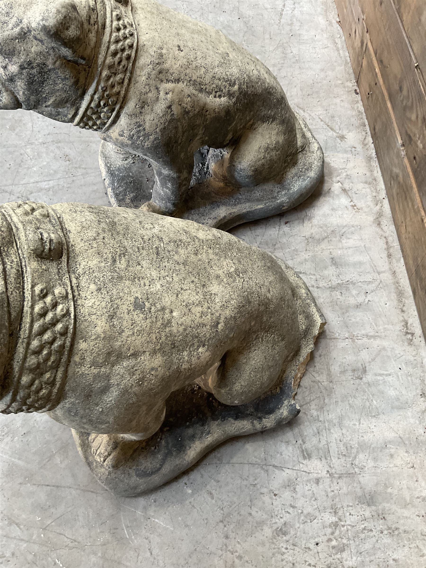 Pair of cast stone garden British bulldogs, on shaped plinths