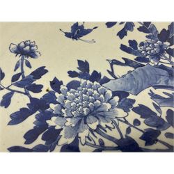 19th century Chinese blue and white charger, decorated with a bird perched upon a rock amongst blossoming peonies, and butterfly in flight, within a trellis border interspersed with butterflies in reserves, the underside rim decorated with bamboo fronds, D40cm
