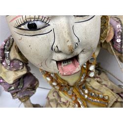 Large string puppet, probably Thai or Burmese, modelled as a woman in traditional costume embellished with sequins, the painted head with articulated mouth, the wood body and hands jointed, L70cm
