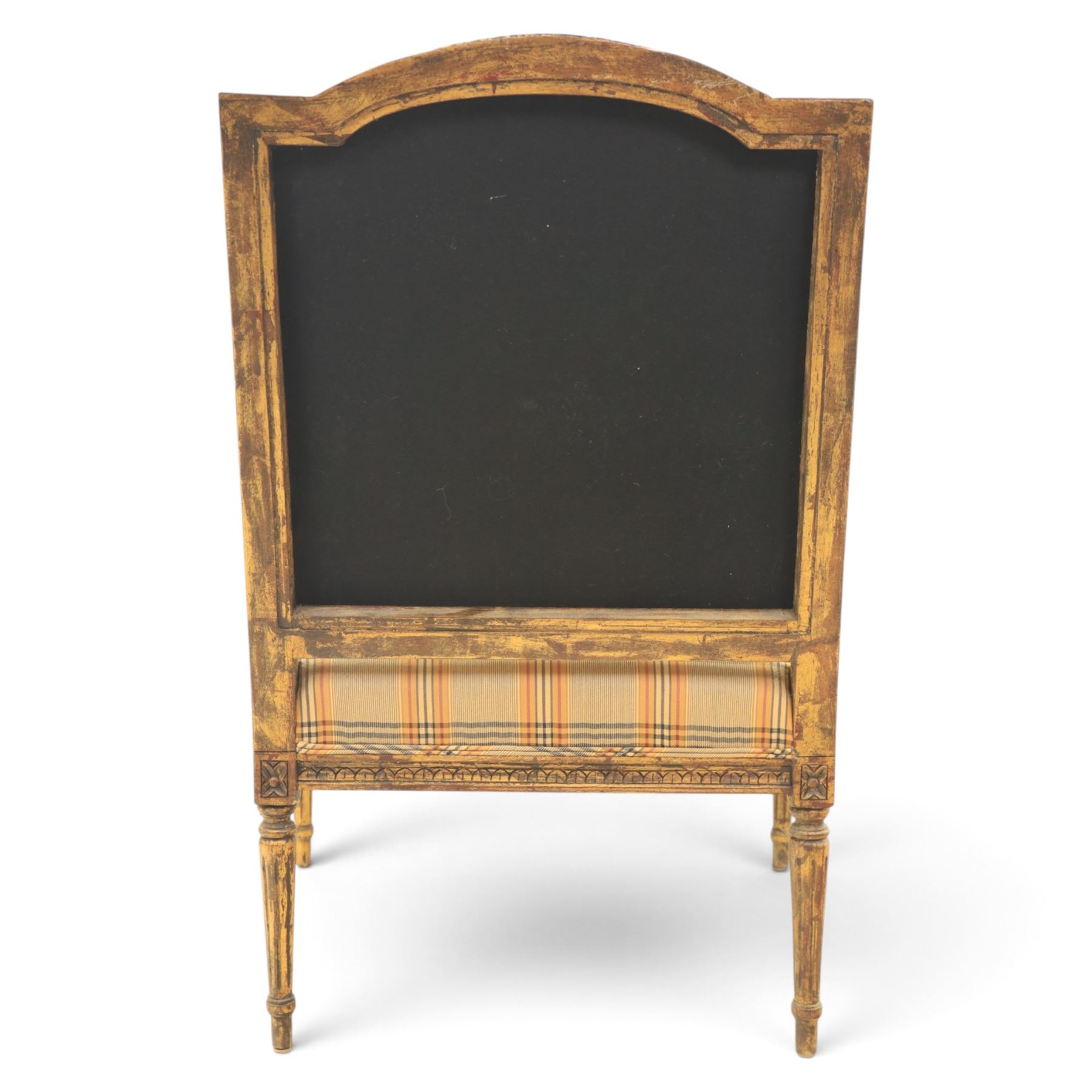 Louis XVI style painted fauteuil, the shaped padded back and overstuffed seat upholstered in cream tartan fabric, with scrolling open arms on fluted supports, the moulded frame with carved ribbon twist, rosette and husk decoration, raised on turned and fluted tapering legs