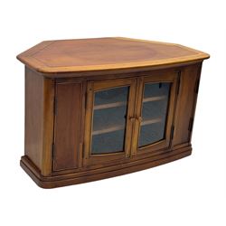 Contemporary cherry wood corner TV unit, canted top over central glazed double doors opening to shelves for media storage, flanked by side storage compartments, on a plinth base