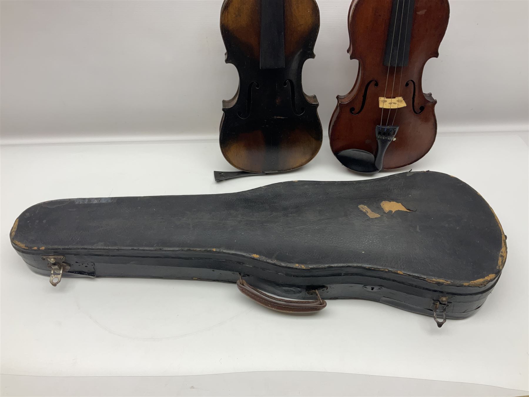 German violin c1890 with 36cm two-piece maple back and ribs and spruce top; bears label 'Antonius Stradivarius Cremona Faciebat Anno 1729' L59.5cm overall; in ebonised wooden 'coffin' case; and two German violins c1890 for completion - one bearing a Stradivarius label, the other a Ruggeri label; both in carrying cases (3)