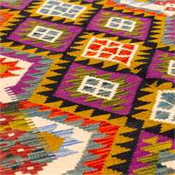 Afghan Maimana flatweave kilim, central field features large bold nested diamond motifs and stylized geometric lozenge patterns on olive purple, blue, and green tone ground, border stripe in teal ground, and fringe