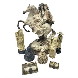 Composite figure of a couple upon a rearing horse, together with a collection of resin immortals and two bone chests 