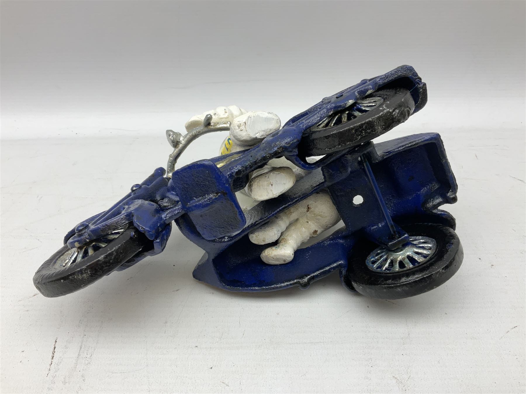 Cast iron figure of Michelin Man on motorbike modelled with smaller seated Michelin man in sidecar, H16cm