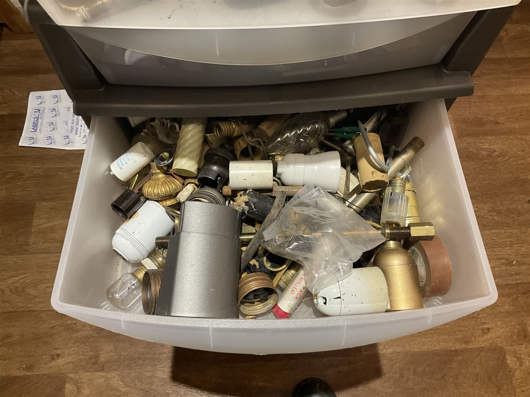 Large quantity of light fitting spare parts and accessories in plastic floor standing six-drawer chest