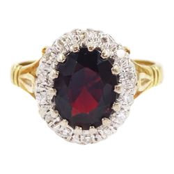 18ct gold oval cut garnet and round brilliant cut diamond cluster ring, London 1975