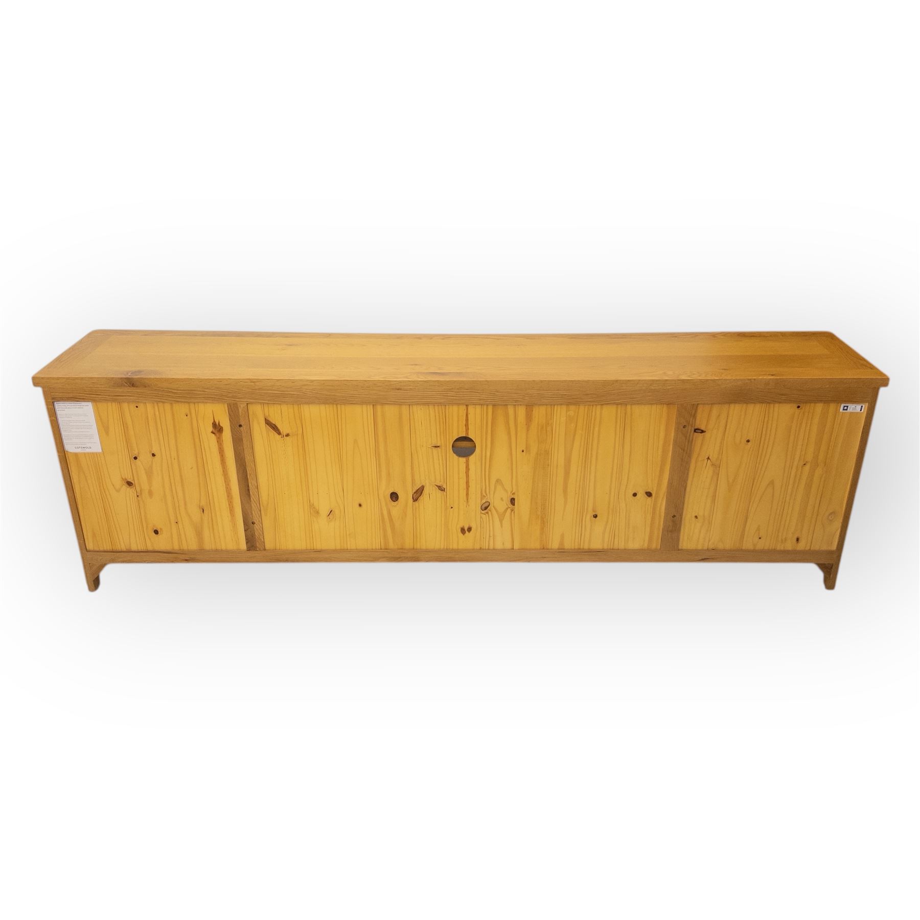 Cotswold & Co - large light oak media stand, rectangular top above central open shelf, double drawer flanked by two panelled cupboard doors, fitted with metal cup and knob handles