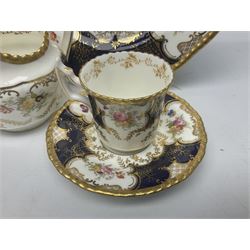 Coalport cobalt blue batwing pattern tea wares, decorated with finely enamelled floral sprays within gilt reserves, comprising teacup trio, coffee can and saucer and other cup and saucer, twin handled cake plate, milk jug and open sucrier, and circular plate retailed by T. Goode & Co London, pattern no Y2665,  all with green Coalport AD 1750 marks beneath, largest W26cm (11)