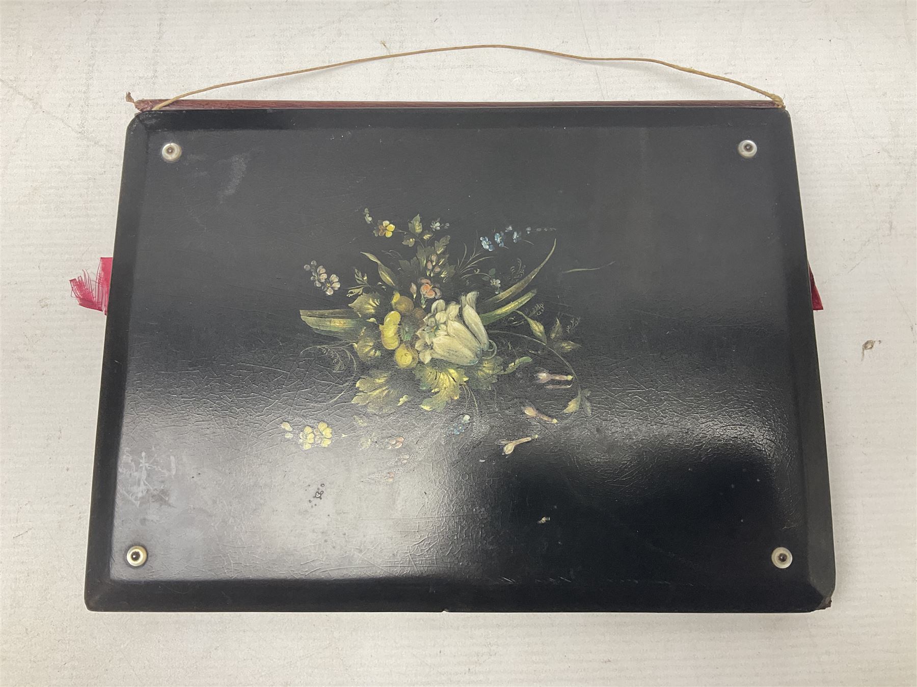 Victorian desk ink blotter, decorated with painted spray of flowers within stylised gilt rococo spandrels with mother of pearl fixings, together with a Victorian photo album containing interior leaves with apertures of various sizes and shapes of portraits surrounded by printed sea and dock scenes, blotter L28cm