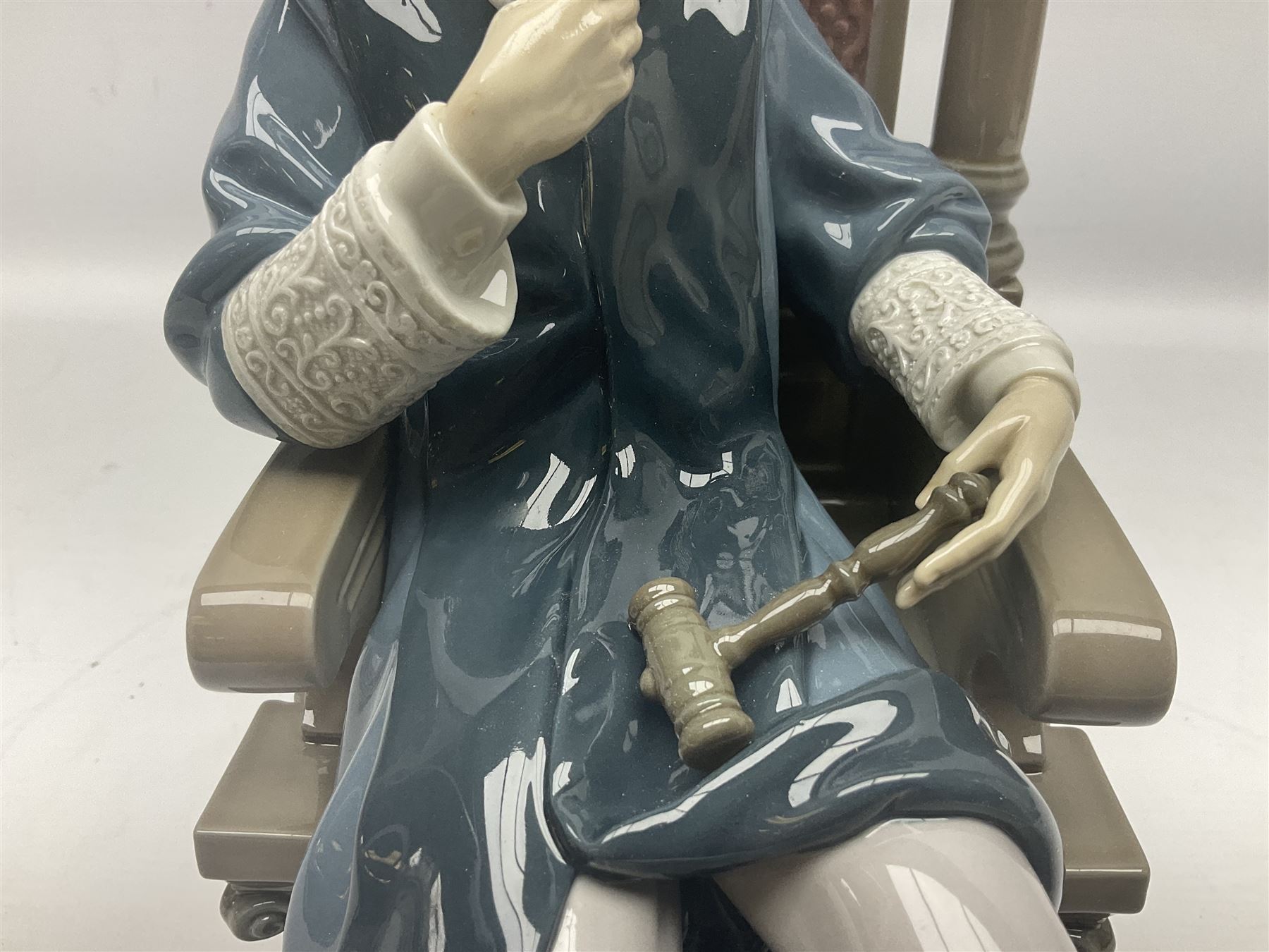 Lladro figure, Justice, modelled as a judge sat in a char, sculpted by Salvador Furió, with original box, no 5489, year issued 1988, year retired 1993, H34cm 