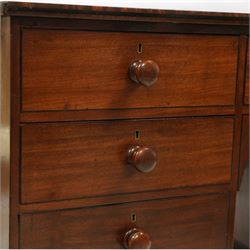 Early 19th century mahogany kneehole desk, rectangular moulded top over an arrangement of nine drawers with turned mahogany handles, arched kneehole recess, raised on short turned legs with brass cups and castors