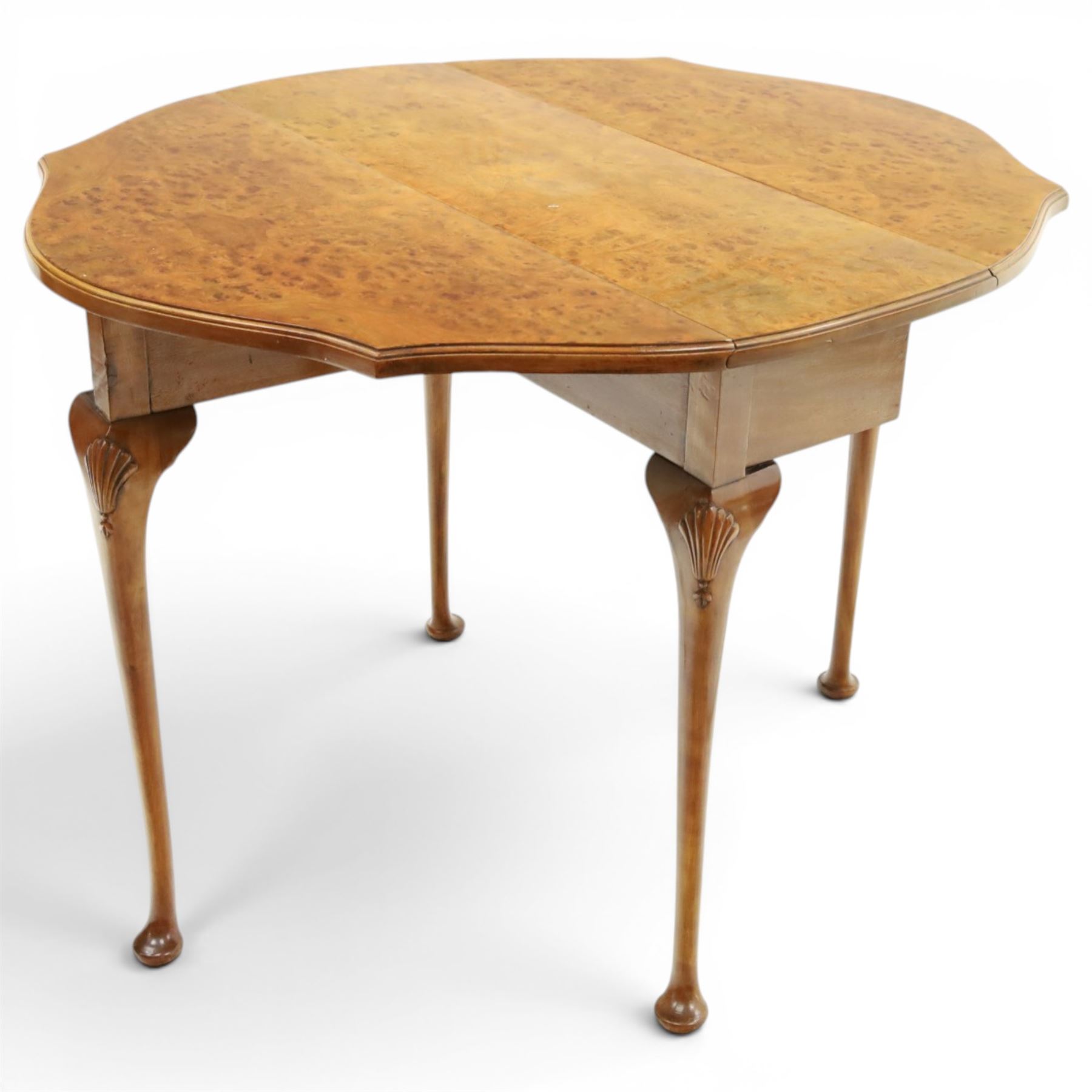 Queen Anne design walnut drop-leaf table, figured top with serpentine drop leaves, shell carved knees on cabriole supports