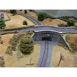  N-Guage: table top model railway layout with panoramic raised sides, undulating surface with tracks and sidings, rows of houses and church, bridge, tunnel, trees etc L150cm W78cm together with Graham Farish 2-6-2 Prairie Tank locomotive, three passenger coaches and nine wagons, Lima passenger coach and four wagons, predominantly boxed and a H & M Control unit  