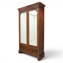 Edwardian walnut double wardrobe, featuring two mirrored doors with bevelled plates, carve...