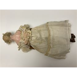 Victorian wax shoulder head doll with pale complexion, applied hair, inset glass eyes and fabric covered jointed body with kid leather lower arms; white linen dress and undergarments H50cm