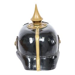 WWI Prussian M1895 Pickelhaube, the black leather skull with brass spike finial, brass eagle helmet plate and leather chin strap, one side with a black cockade,  the other black and red, with leather lining